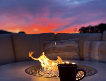 Bear and Grin Inn | Deep Creek Lake, Maryland Hot drink by the firepit at Bear and Grin Inn during sunset at Deep Creek Lake Maryland