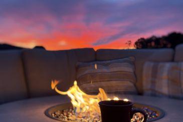 Hot drink by the firepit at Bear and Grin Inn during sunset at Deep Creek Lake Maryland